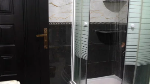 In the bathroom in the shower cabin water flows from the shower. Stock Footage 101737265