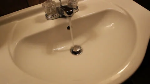 Bathroom Sink Running Until Female Hand Turns Knob to Drip (59) Stock Footage 24789694