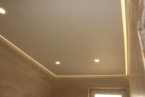 Bathroom stretch ceiling with led strip and recessed lighting Stock Photos