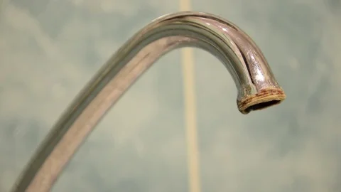 Bathroom tap leaking water drops on grey background Stock Footage 83850391