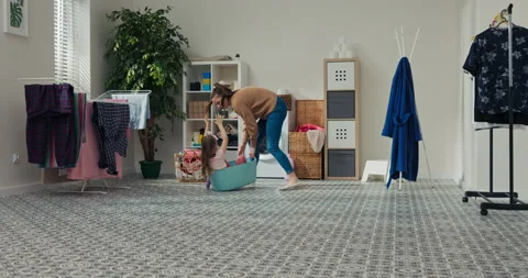 In bathroom there are clothes hanging, washing machine and shelf with bathroom Stock Footage 218303511