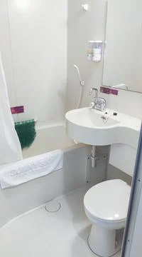 Bathroom, toilet, mirror, washbasin, towel. Stock Photos