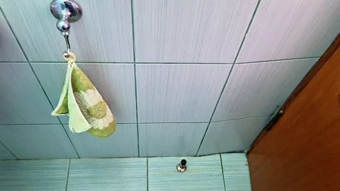 Bathroom Wall with Hanging Patterned Towel and Metal Hook Fixture Video stock 331119418