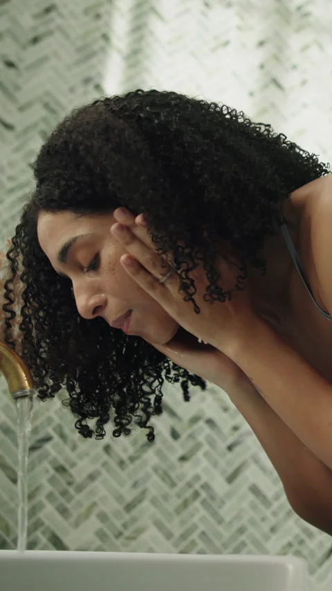Bathroom, water and washing face of woman in home for skincare, dermatology or Stock Footage 337153262