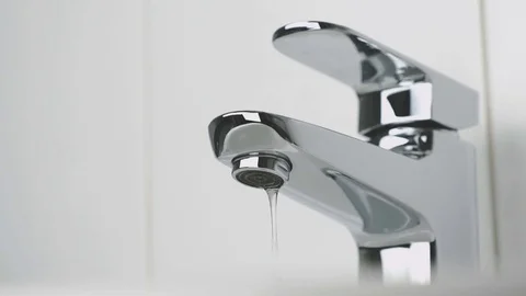 Bathroom. Water dripping from chrome-plated faucet Stock Footage 72474590