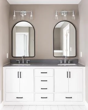 A bathroom with a white cabinet and brown walls. Stock Photos