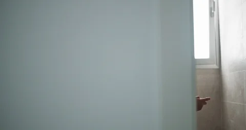 In the bathroom young man on toilet rela... | Stock Video