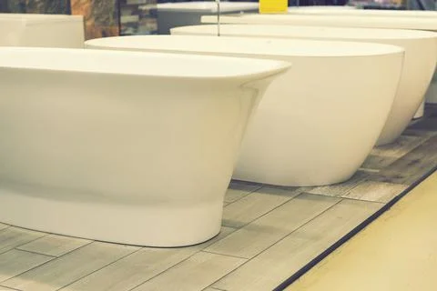 Baths in the plumbing store. Sanitary engineering shop. White bathrooms. bath Stock Photos