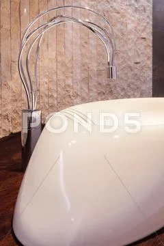 Bathtub with decorative tap Stock Photos