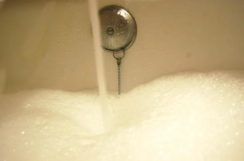 Bathtub filling up with bubbles Stock Photos