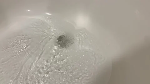 Bathtub with water. Preparing a bath, hot water flows from the tap. water with b Stock Footage 201606424