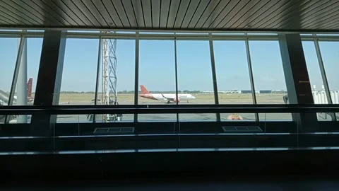 A Batik Air plane being parked from inside the airport terminal waiting room. Stock Footage 258038852