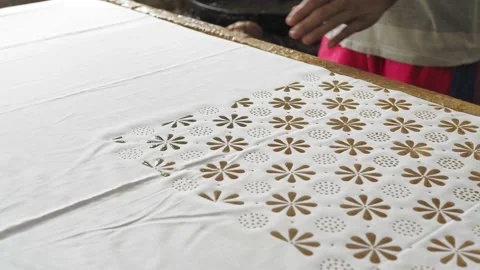 Batik cap  stamp process copper stamps hot wax create motif onto fabric Stock Footage 143753000