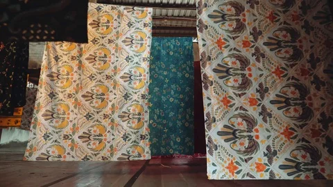 Batik fabric drying on ropes in factory in Java, Indonesia Видео 90662942