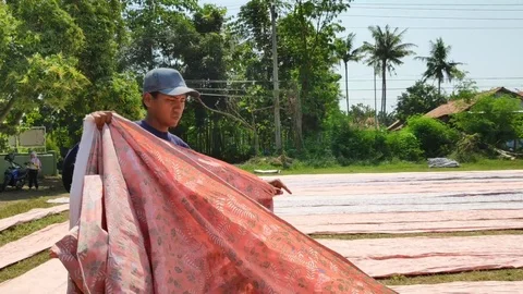 Batik workers when drying batik cloth Stock Footage 112765772