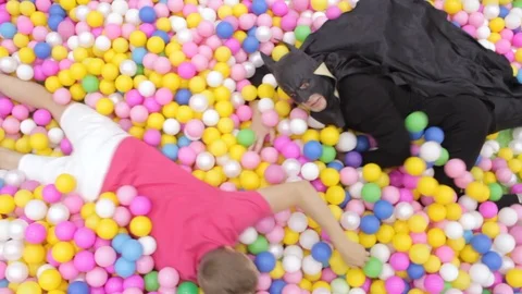 Batman swims in the pool with plastic balls Stock Footage 111200574