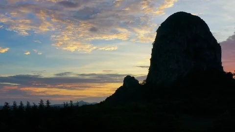 Bats fly out of the cave in the mountains at sunset. Stock Footage 111905673