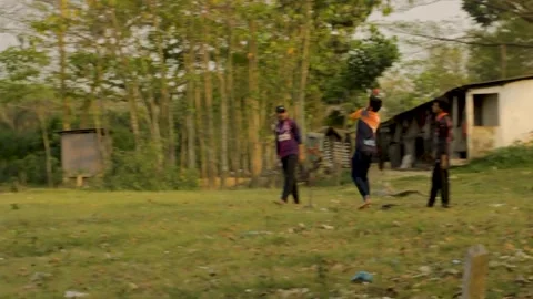 The batsman hit a six after bowling in a local cricket game Stock Footage 293939735