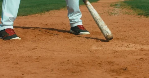 Batter baseball player hits a ball against, CU on legs. 4K UHD 60 FPS SLO MO RAW Stock Footage