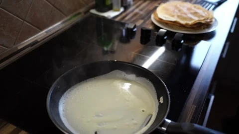 Batter bubbles and steams as it bakes in a pan on the stove Stock Footage 270133634
