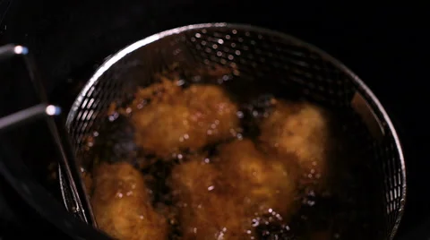 Batter-fried chicken meat nuggets are all deep fried well done in hot boiling Stock Footage