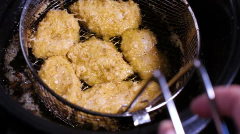 Batter-fried chicken meat nuggets are all deep fried well done in hot boiling Stock Footage 66784076