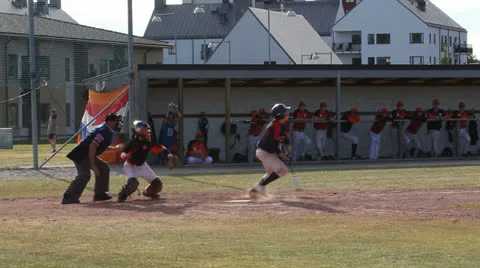Batter reaches first base Stock Footage 25824412