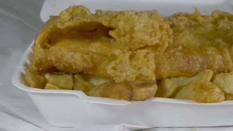 Battered fish and chips with curry sauce, takeaway meal. Video stock 138236668