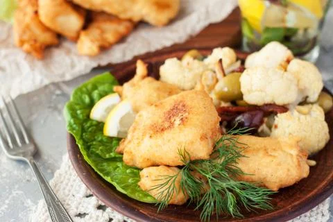Battered fish with cauliflower Stock Photos
