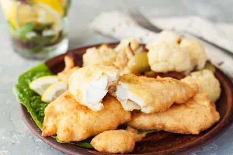 Battered fish with cauliflower Stock Photos