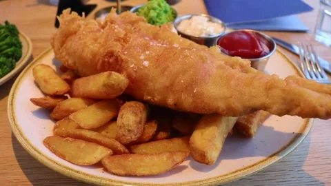 Battered Fish Cod Haddock and Chips French Fries Potato Wedges Ketchup Condiment Stock Footage 276368333