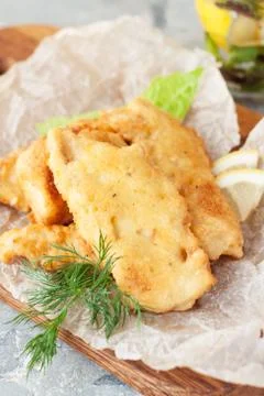 Battered fish with lemon Stock Photos