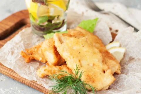 Battered fish with lemon Stock Photos