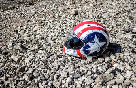 Battered motorcycle helmet on the beach Stock Photos
