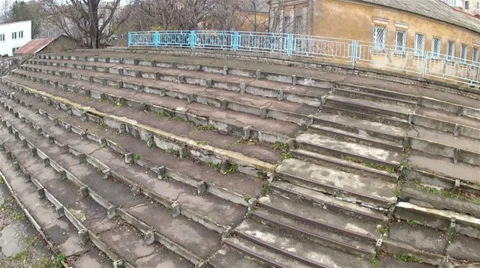 Battered old stadium steps in. Aerial Stock-Footage 32907434