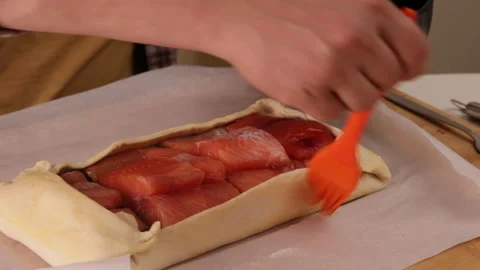 Battered salmon on a baking sheet on baking paper Stock Footage 289429993