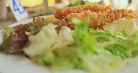 Battered shrimp, green salad, lemon and sauce. Side view, close-up. Restaurant 動画素材 252127127