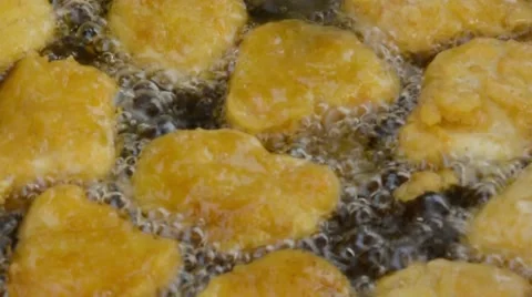 Batterfried chicken nuggets are all deep fried in American fast food restaurant. Stock Footage