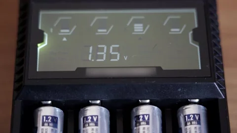 Batteries in the charger. Charge indicator. Video stock 130173311