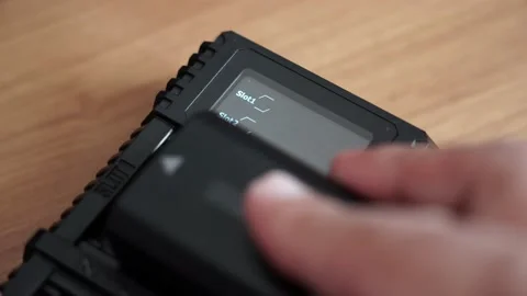 Batteries in the charger. Charge indicator. Video stock 130175223
