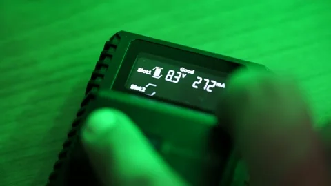 Batteries in the charger. Charge indicator. Stock Footage 130175933