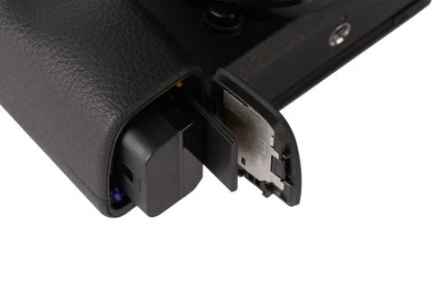 Battery and sdxc memory card in a camera slot Stock Photos