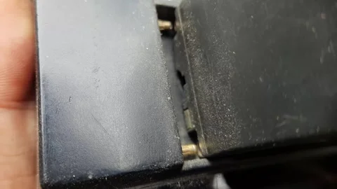 Battery Being Inserted into Charger in Macro Shot Stock Footage 310143032