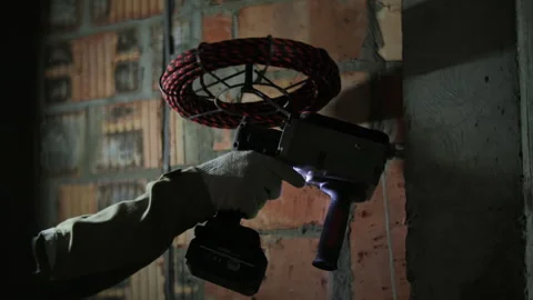 Battery Cable Puller in the hands of a worker Stock Footage 295774040