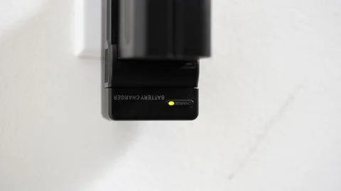 Battery charger appliance pulled from wall home interior plug socket Stock Footage 233318707