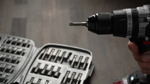 Battery cordless screwdriver and set screwdriver bits on a wooden background Stock Footage 305894329