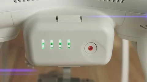 Battery for drone with button and blinking green indicators, close-up Stock Footage 75354830