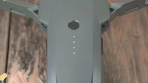 Battery for drone with button and blinking green indicators, close-up Stock Footage 141855456