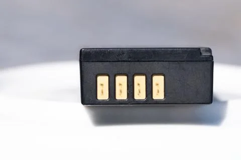 Battery for DSLR or system camera. Rechargeable on white with gray background Foto stock