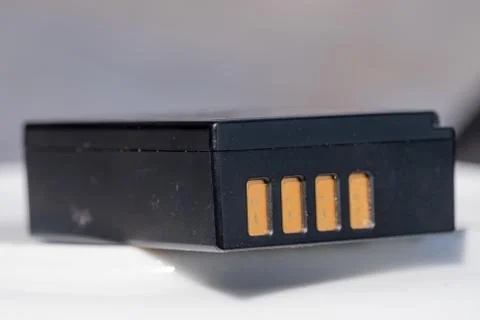 Battery for DSLR or system camera. Rechargeable on white with gray background Foto stock